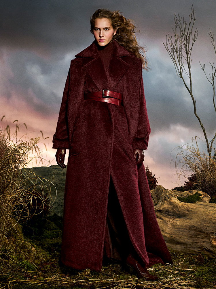 Max Mara Untamed Heroine campaign look with long coat, sleeveless coat and cherry-coloured Mary Janes.